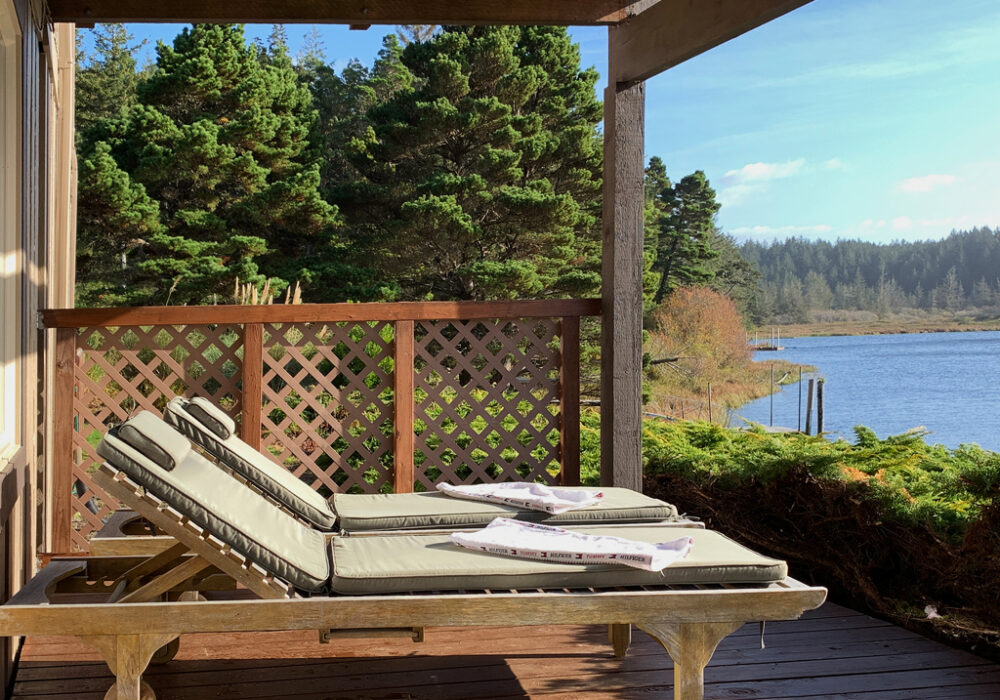 Lower porch with loungers at the Floras Lake Getaway
